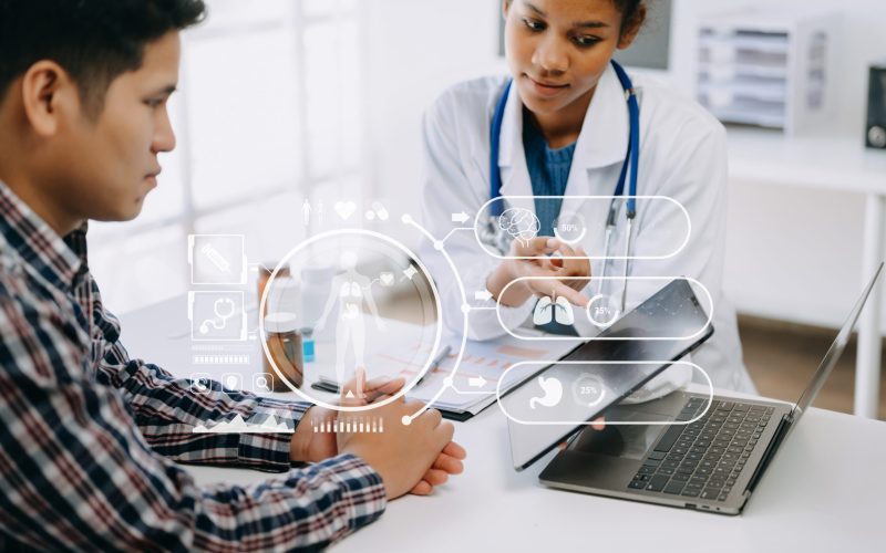 Asian Doctor and patient discussing something while sitting at the table . Medicine and health care concept. with virtual icon